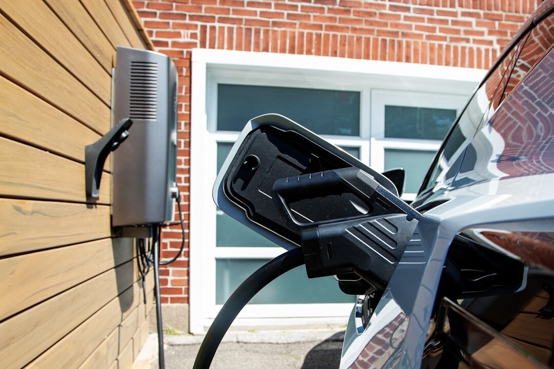Modern electric vehicle charging at a fast-charging station at dusk