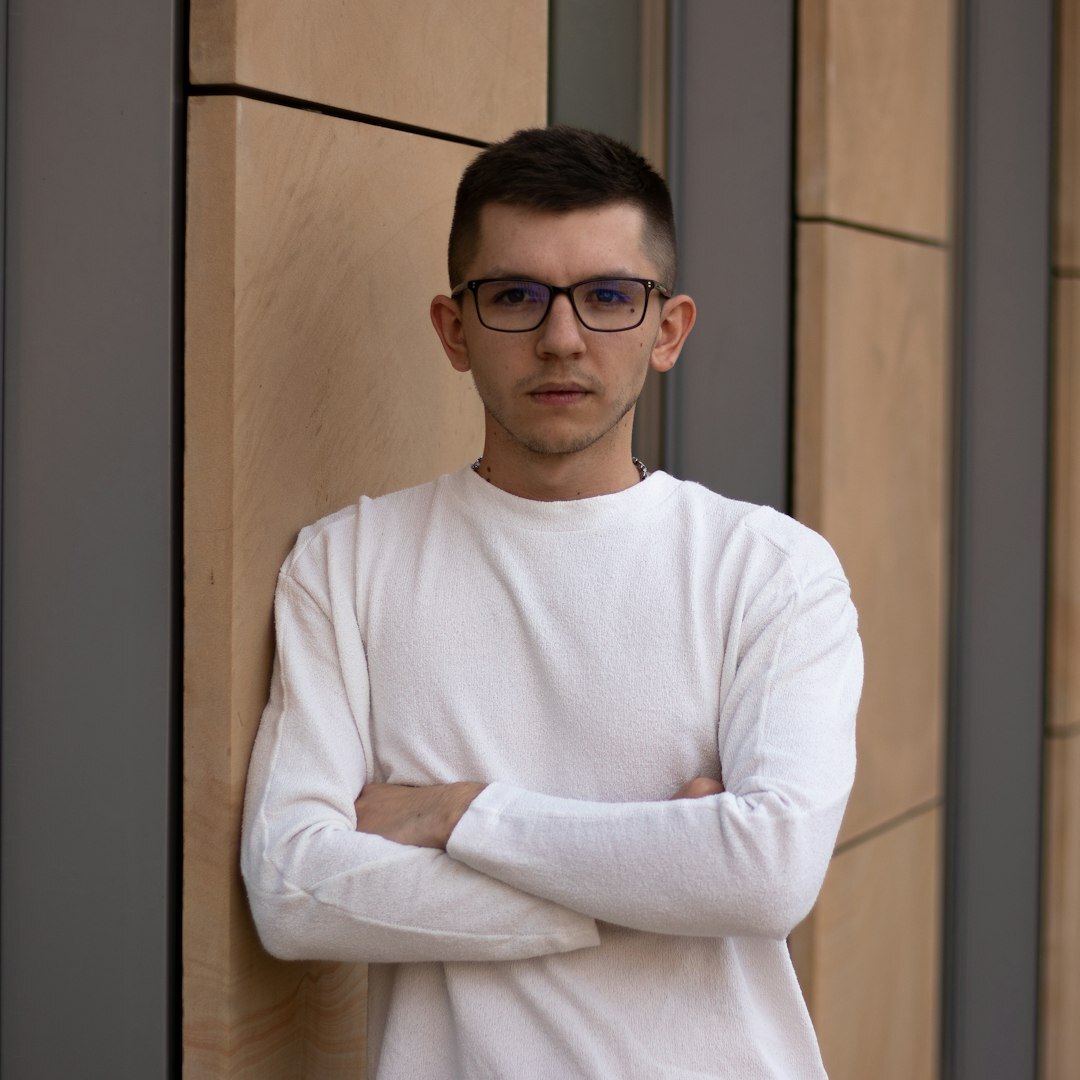 Professional headshot of male software architect in his 50s with glasses